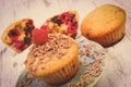 Vintage photo, Baked muffins with raspberries and grated chocolate on wooden background, delicious dessert