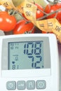 Vintage photo, Blood pressure monitor with result of measurement, fruits with vegetables and centimeter, healthy lifestyle