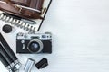 vintage photo camera with equipments on white wooden board background flat view Royalty Free Stock Photo