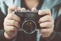 Vintage photo camera in the hands of man, soft focus. Royalty Free Stock Photo