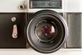 Vintage photo camera with optical lens and aperture blades, front view as icon Royalty Free Stock Photo