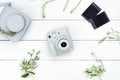 Vintage photo camera on white background with photo cards. Polaroid camera. Instax white camera. Flat lay. Royalty Free Stock Photo