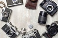 Vintage photo cameras and lenses on a white table. View from above Royalty Free Stock Photo