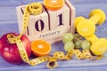 Vintage photo, Cube calendar, fruits, dumbbells and tape measure, new years resolutions