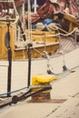 Vintage photo, Detail of yachting, Rope with old mooring bollard and yacht in background Royalty Free Stock Photo