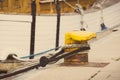 Vintage photo, Detail of yachting, Rope with old mooring bollard and yacht in background Royalty Free Stock Photo