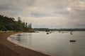 Vintage photo of an empty curve of a beach on a stormy evening