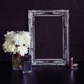 Vintage photo frame and flowers on a black textured background. Place for your text Royalty Free Stock Photo