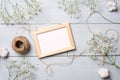Vintage photo frame with flowers on light blue wooden background. Banner mockup for congratulation with womans or mother day, wedd