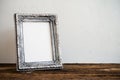 Vintage photo frame on old wooden table over white wall background Royalty Free Stock Photo