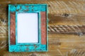 Vintage photo frame over wood background with empty white canvas Royalty Free Stock Photo