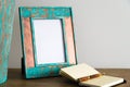 Vintage photo frame on wooden table over white wall background Royalty Free Stock Photo