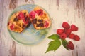 Vintage photo, Fresh baked muffins with chocolate and raspberries on wooden background, delicious dessert Royalty Free Stock Photo