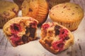 Vintage photo, Fresh baked muffins with chocolate and raspberries on wooden background, delicious dessert Royalty Free Stock Photo