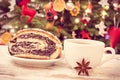 Vintage photo, Fresh baked poppy seeds cake, coffee or tea and christmas tree with lights and decoration Royalty Free Stock Photo