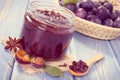 Vintage photo, Fresh plum marmalade in jar, spices and ripe fruits in wicker basket, healthy sweet dessert Royalty Free Stock Photo