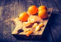 Vintage photo of fresh tangerines on wooden cutting board Royalty Free Stock Photo