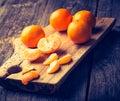Vintage photo of fresh tangerines on wooden cutting board Royalty Free Stock Photo