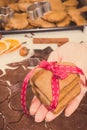 Vintage photo, Hand of woman with gingerbread or cookies for Christmas time and accessories for baking Royalty Free Stock Photo