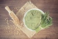 Vintage photo, Heap of young powder barley, barley grass and grain on jute canvas, wooden background