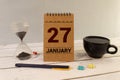 Vintage photo, January 27th. Date of 27 January on wooden cube calendar, copy space for text on board