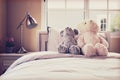 Vintage photo of kids room with dolls and pillows on bed Royalty Free Stock Photo