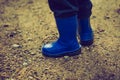 Vintage photo of little child legs in rain boots