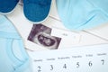 Vintage photo, Pregnancy test, ultrasound scan of baby, clothing for newborn and calendar, expecting for baby Royalty Free Stock Photo