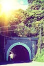 Vintage photo of a road entering a tunnel. Concept of paths we take and shortcuts. Toned image