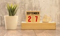 Vintage photo, September 27th. Date of 27 September on wooden cube calendar, copy space for text on board Royalty Free Stock Photo