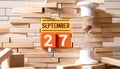 Vintage photo, September 27th. Date of 27 September on wooden cube calendar, copy space for text on board Royalty Free Stock Photo