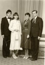 Vintage photo shows a bride, bridegroom and parents. Retro black and white photography. Circa 1980. Royalty Free Stock Photo