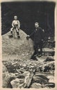 Vintage photo shows man and child-boy pose outdoor during for a walk in the mountains. Antique black and white portrait