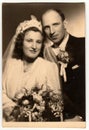 Vintage photo shows newlyweds pose after wedding ceremony. Retro black and white studio photography. Circa 1940s. Royalty Free Stock Photo