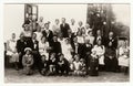 A vintage photo shows people in the back yard (during rural wedding feast), circa 1920