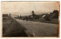 Vintage photo shows the road in the village. Retro black and white photography. Circa 1950s.