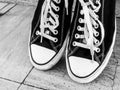 Old pair of tennis shoes - old trainers black and white photograph Royalty Free Stock Photo