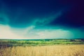 Vintage photo of storm clouds over wheat field Royalty Free Stock Photo