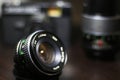 Vintage photo video equipment. 28mm f2.8 lens. Lenses and cameras in the background Royalty Free Stock Photo