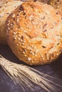 Vintage photo, Wholegrain rolls or bread for breakfast and ears of rye or wheat grain Royalty Free Stock Photo