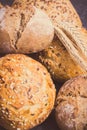 Vintage photo, Wholegrain rolls or bread for breakfast and ears of rye or wheat grain Royalty Free Stock Photo