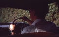 Vintage photo 1963, of young man driving car. Royalty Free Stock Photo