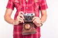 Vintage, photographer and people concept - retro camera in man`s hands over the white background Royalty Free Stock Photo