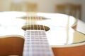 Acoustic guitar strings on wooden table in the room, close up top view and sunlight with empty space for you text Royalty Free Stock Photo