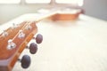 Acoustic guitar strings on wooden table in the room, close up top view and sunlight with empty space for you text Royalty Free Stock Photo