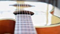 Acoustic guitar strings on wooden table in the room, close up top view and sunlight with empty space for you text Royalty Free Stock Photo