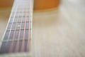 Acoustic guitar strings on wooden table in the room, close up top view and sunlight with empty space for you text