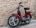 Vintage Piaggio red scooter parked in the street