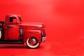 Vintage pickup truck from the 50s, Ford on a red background. toy or model Royalty Free Stock Photo