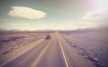 Vintage picture of car on endless country highway, Ruta 40.